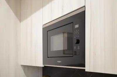 a microwave oven is attached to a wall at Valencia Central Flats - Exclusiva, junto al Roig Arena in Valencia