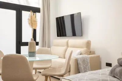 a living room with a table and a couch at Valencia Central Flats - Exclusiva, junto al Roig Arena in Valencia