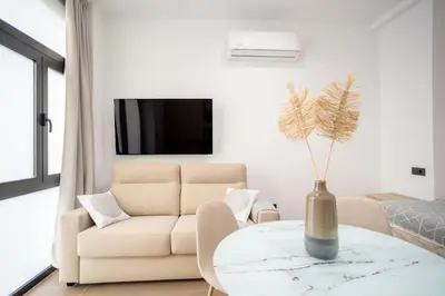 a living room with a couch and a table at Valencia Central Flats - Exclusiva, junto al Roig Arena in Valencia