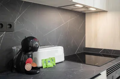 a kitchen counter with a white toaster on a counter top at Valencia Central Flats - Exclusiva, junto al Roig Arena in Valencia