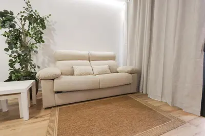 a living room with a couch and a chair at ADapartments in Valencia