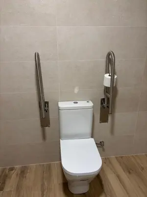 a toilet in a bathroom with two toilet paper holders at Valencia City Scapes in Valencia