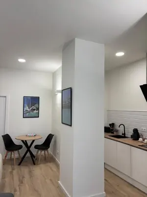 a kitchen with white walls and a table and chairs at Valencia City Scapes in Valencia
