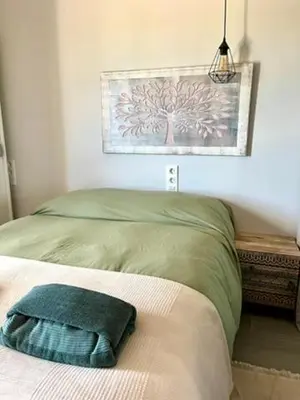 a bedroom with a bed with a tree picture on the wall at Apartamento boutique luminoso a 5 min del metro in Bétera
