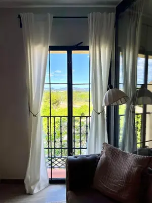 a living room with a couch in front of a window at Apartamento boutique luminoso a 5 min del metro in Bétera