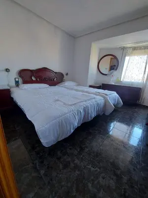 a bedroom with a large white bed in a room at Reina Beach House in Valencia