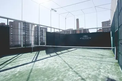 a tennis court on the roof of a building at Fitness & Spa, Suite Atalanta Valencia in Valencia