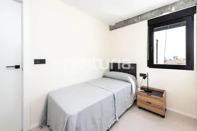 a white bedroom with a bed and a window at Carme Sky in Valencia