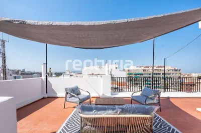 a balcony with two chairs and a couch on a roof at Carme Sky in Valencia