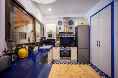 a blue and white kitchen with a refrigerator at Portrait Boutique Villa in Valencia