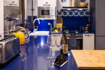 two wine glasses sitting on a counter in a kitchen at Portrait Boutique Villa in Valencia