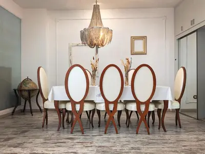 a dining room with a table with chairs and a chandelier at Portrait Boutique Villa in Valencia