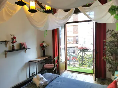 a bedroom with a bed and a sliding glass door at Portrait Boutique Villa in Valencia