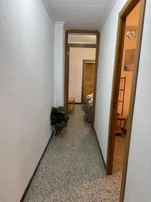 a hallway with a door leading to a room at Brisa de mar in El Perelló