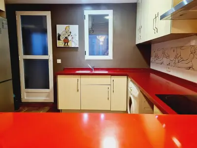 a kitchen with a red counter top and a sink at Padre Luis flat in Valencia