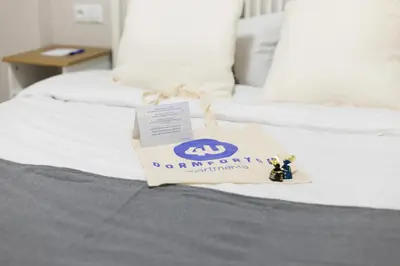 a bag on a bed with a donation sign on it at El Cabañal - Familiar in Valencia