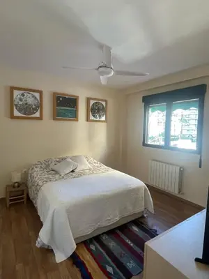 a bedroom with a bed and a ceiling fan at Apartamento Neptuno A4 in Puebla de Farnals
