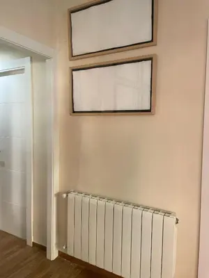 a room with a radiator and a picture on the wall at Apartamento Neptuno A4 in Puebla de Farnals