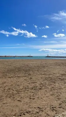 an empty beach with the ocean in the background at Apartamento Neptuno A4 in Puebla de Farnals