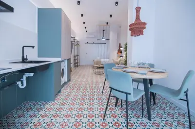 a kitchen with blue cabinets and a table and chairs at District Key - Valencia, Fuencaliente D in Valencia