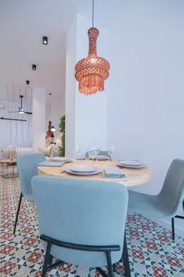 a dining room table with chairs and a chandelier at District Key - Valencia, Fuencaliente D in Valencia