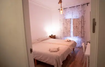 two beds in a room with a window at LOWCOST Beach & CityCenter in Valencia