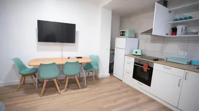 a kitchen with a table and chairs in a kitchen at LOWCOST Beach & CityCenter in Valencia