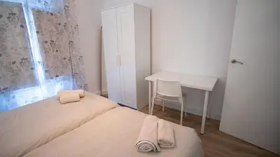 a small bedroom with a bed and a desk at LOWCOST Beach & CityCenter in Valencia