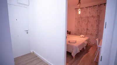 a small bedroom with a bed and a window at LOWCOST Beach & CityCenter in Valencia