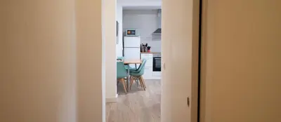 a kitchen and dining room with a table and chairs at LOWCOST Beach & CityCenter in Valencia
