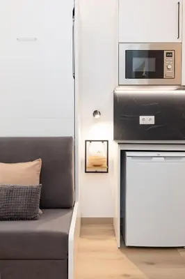 a living room with a couch and a microwave at Ca La Leni Beach 0 in Valencia