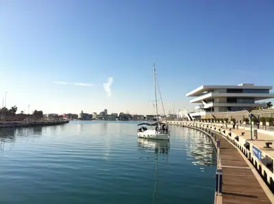 a boat in the water next to a dock at Ca La Leni Beach 0 in Valencia