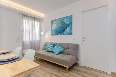 a living room with a couch and a table at Malva Playa in Valencia