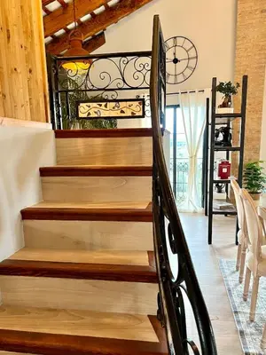 a staircase in a house with a wrought iron railing at Luminoso loft boutique a 5 min del metro in Bétera