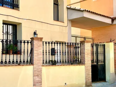 a building with a black wrought iron fence at Luminoso loft boutique a 5 min del metro in Bétera