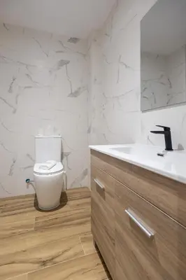 a white bathroom with a toilet and a sink at Lôla Suites by Concept Flats in Valencia