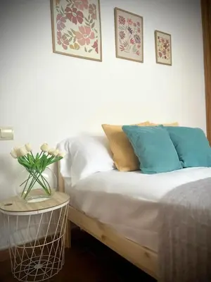 a bedroom with a bed and a vase of flowers on a table at Mar in Valencia