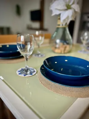 a table with a blue plate and glasses on it at Mar in Valencia