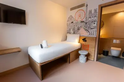 a small room with a bed and a bathroom at easyHotel Valencia Ciutat Vella in Valencia