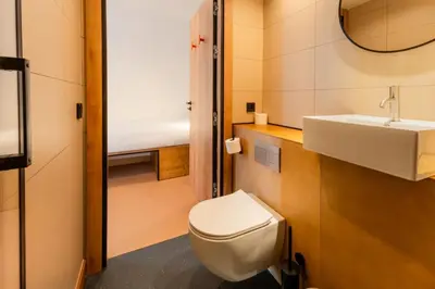 a hotel room with two beds and a desk at easyHotel Valencia Ciutat Vella in Valencia