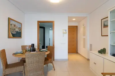 a kitchen and dining room with a table and chairs at Dorm4You Patacona in Valencia