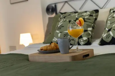 a tray with a glass of orange juice and a plate of food at Dorm4You Patacona in Valencia