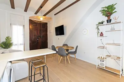 a living room with a table and chairs at Exclusivo apartamento a 5 minutos de la playa in Valencia