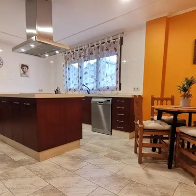 a kitchen with a sink and a table and a stove at Casa Crispetes in Tales