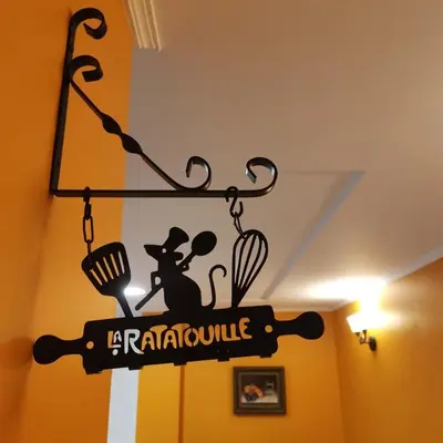 a sign for a restaurant hanging from a ceiling at Casa Crispetes in Tales