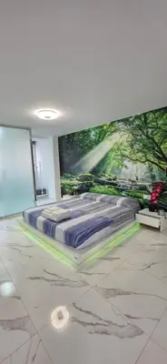 a bed in a room with a painting on the wall at Paradise Home in Valencia
