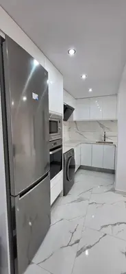 a kitchen with a stainless steel refrigerator and appliances at Paradise Home in Valencia
