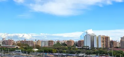 a city with buildings and mountains in the background at Paradise Home in Valencia