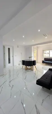 a white living room with a piano and a couch at Paradise Home in Valencia
