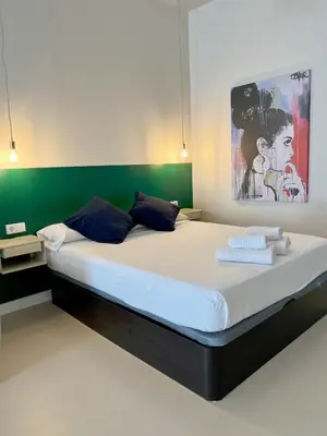 a bedroom with a large bed with towels on it at Osito Hub - Colomer in Valencia